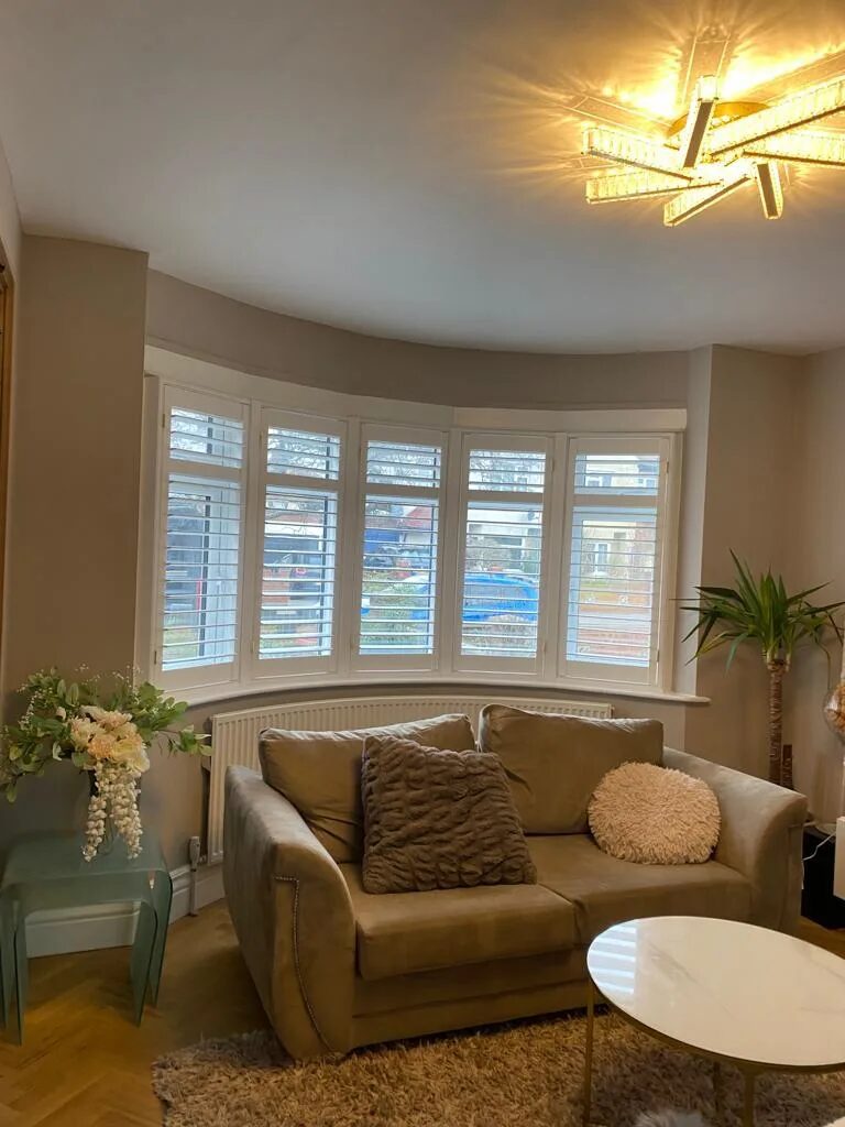 Full-height plantation shutters in a Hull living room
